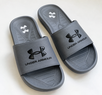 Grey Under Armour men's slides on a white background