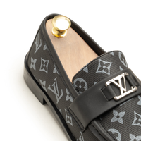 Black cap-toe formal shoe, side view